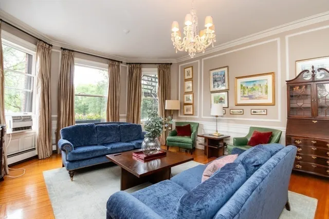 a living room with furniture and a chandelier
