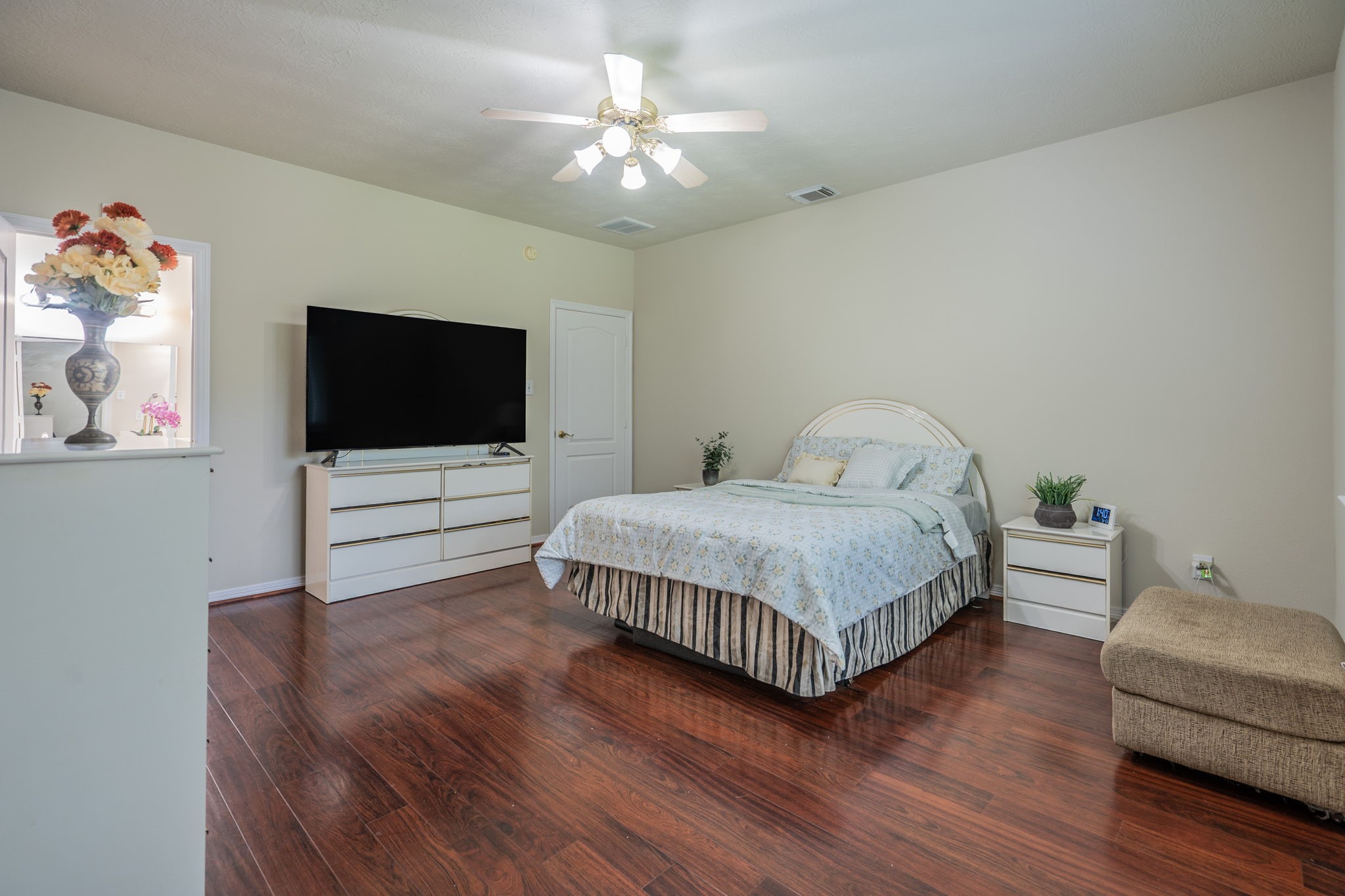 24139 Spring Sunset Drive Spring, TX 77373 - Photo 13 of 26 a bedroom with a bed and a flat screen tv