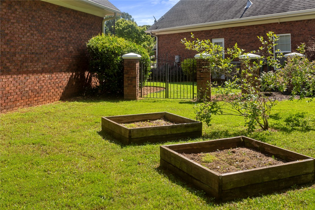 704 Nottingham Court Seneca, SC 29672 - Photo 34 of 48 Raised flower/garden beds and blueberry bushes.
