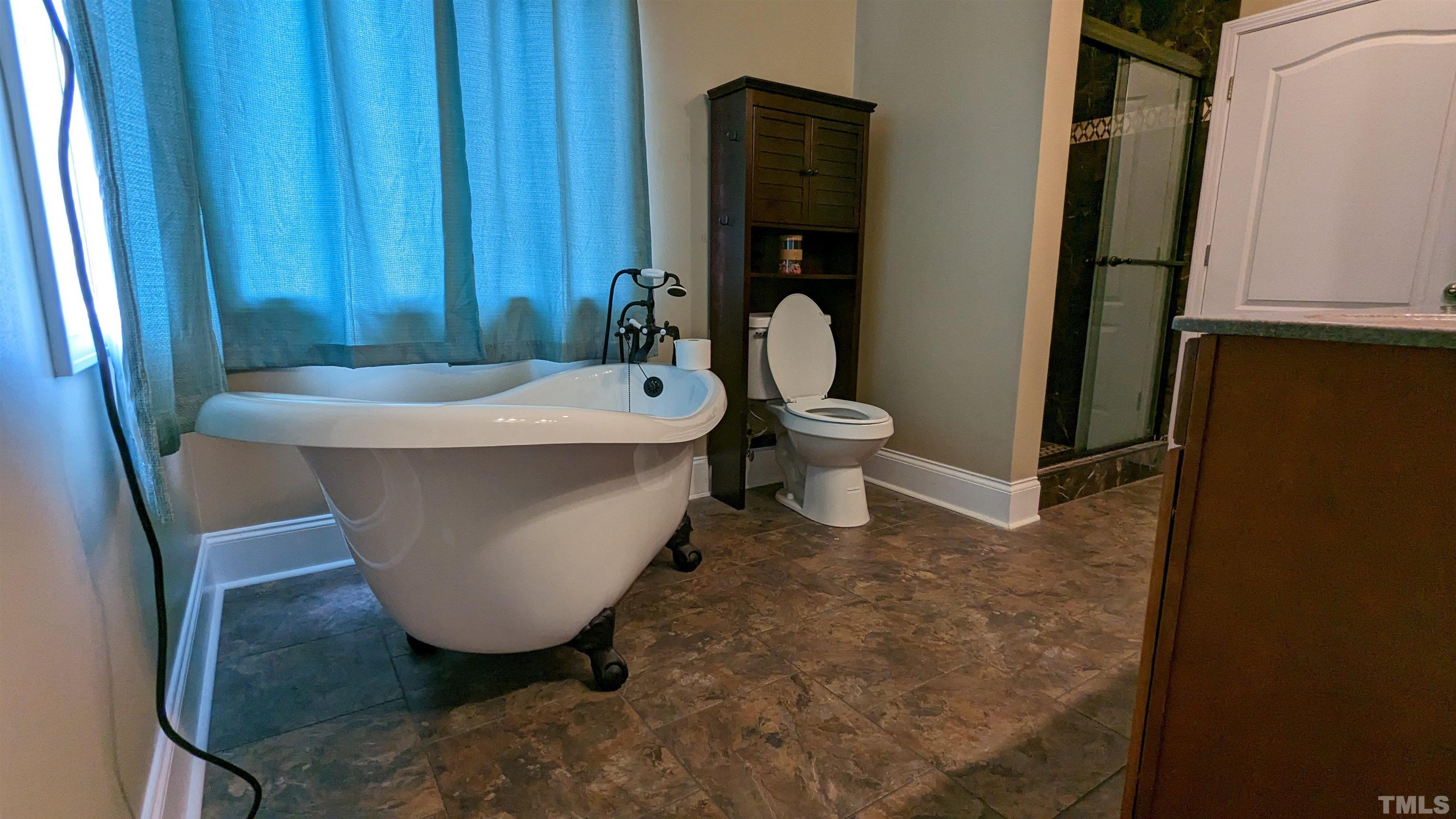 304 Bernard Purvis Road Bennett, NC 27208 - Photo 13 of 33 a white bath tub sitting in a bathroom