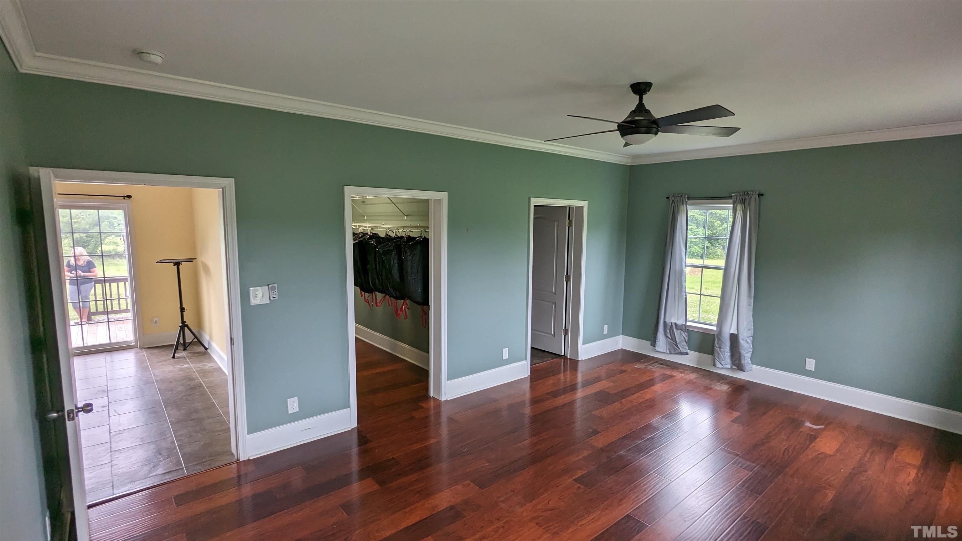 304 Bernard Purvis Road Bennett, NC 27208 - Photo 15 of 33 a view of a hallway with wooden floor and a ceiling fan
