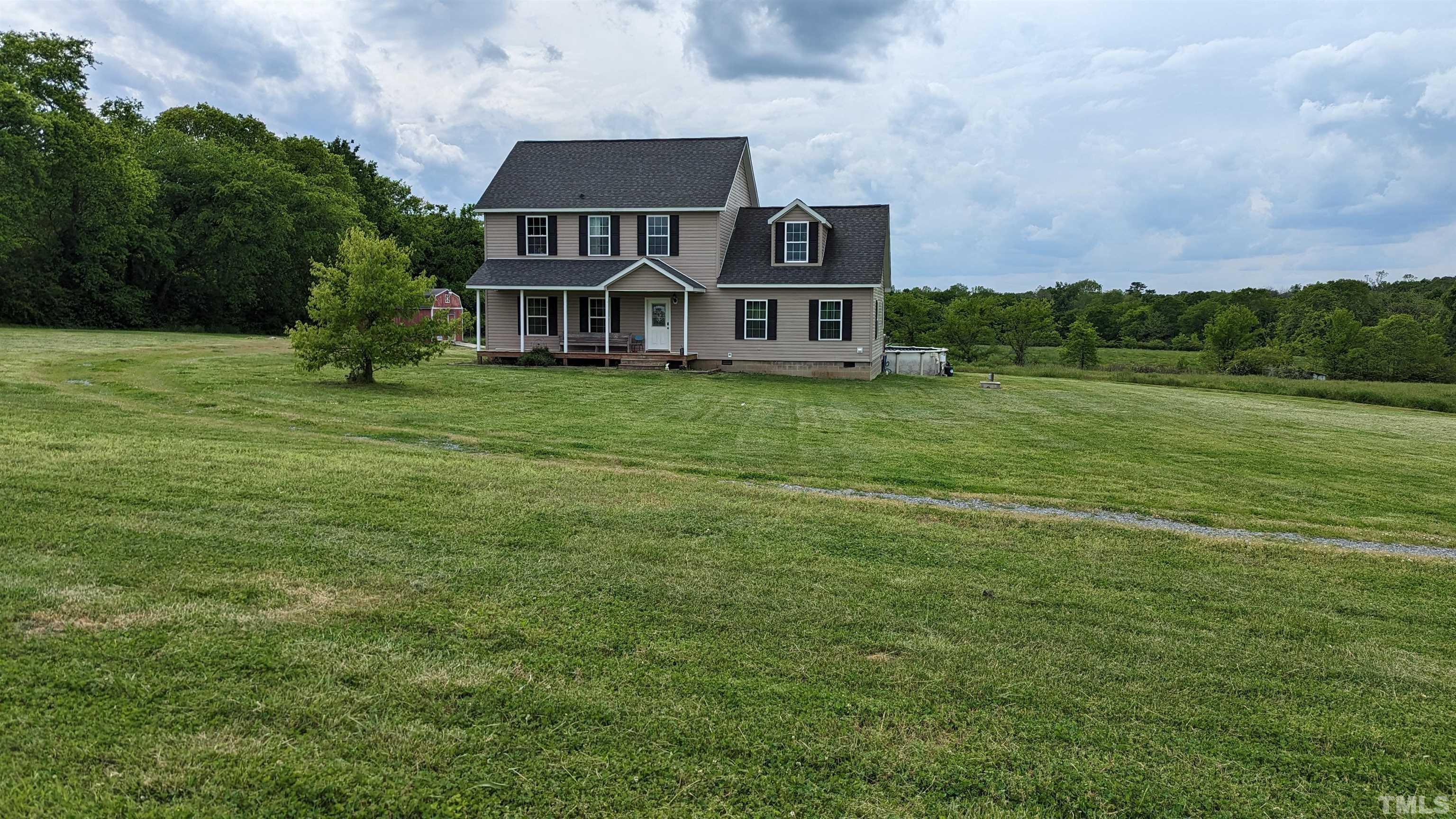 304 Bernard Purvis Road Bennett, NC 27208 - Photo 2 of 33 a front view of a house with a garden