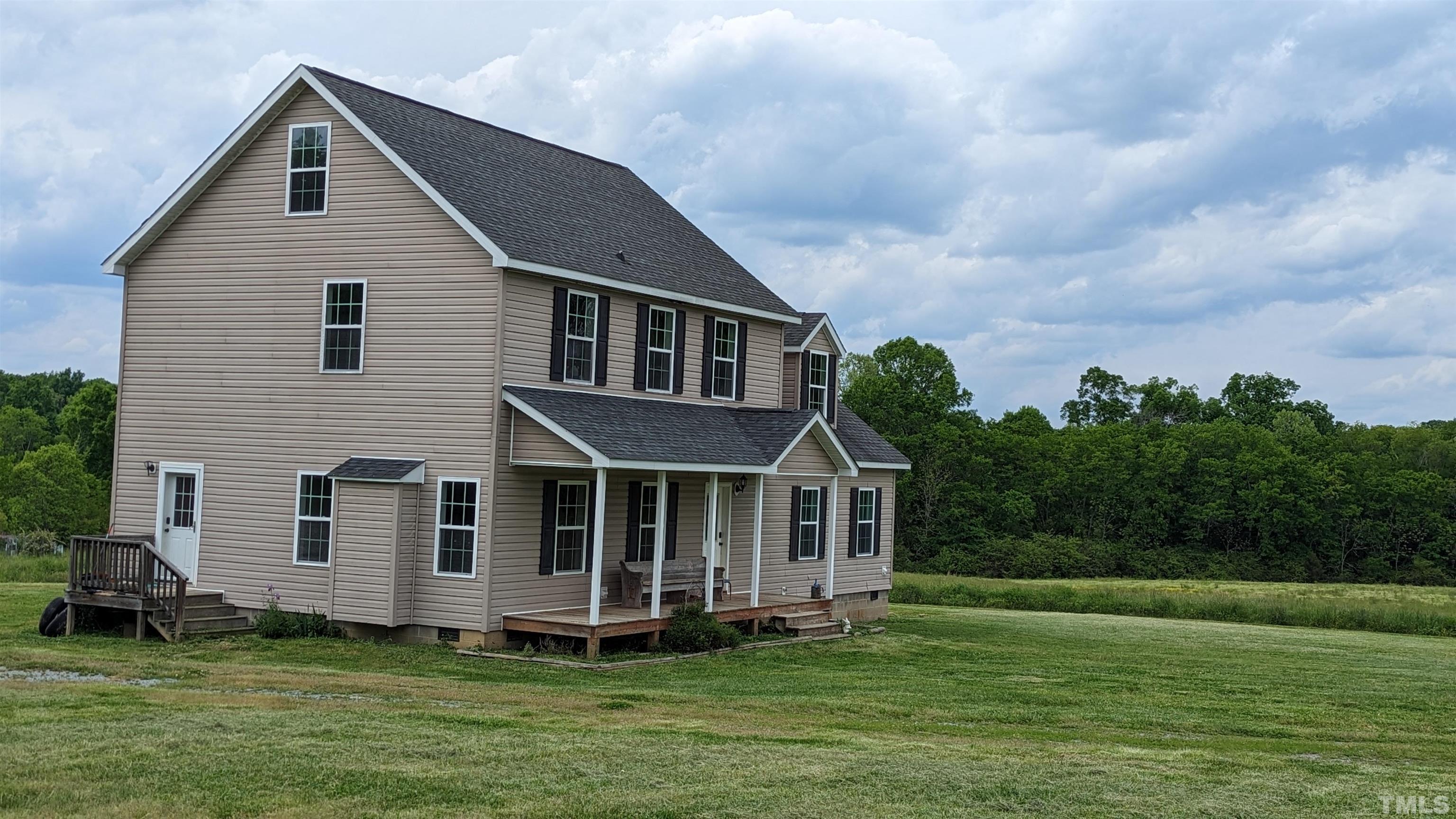 304 Bernard Purvis Road Bennett, NC 27208 - Photo 3 of 33 a front view of a house with a garden