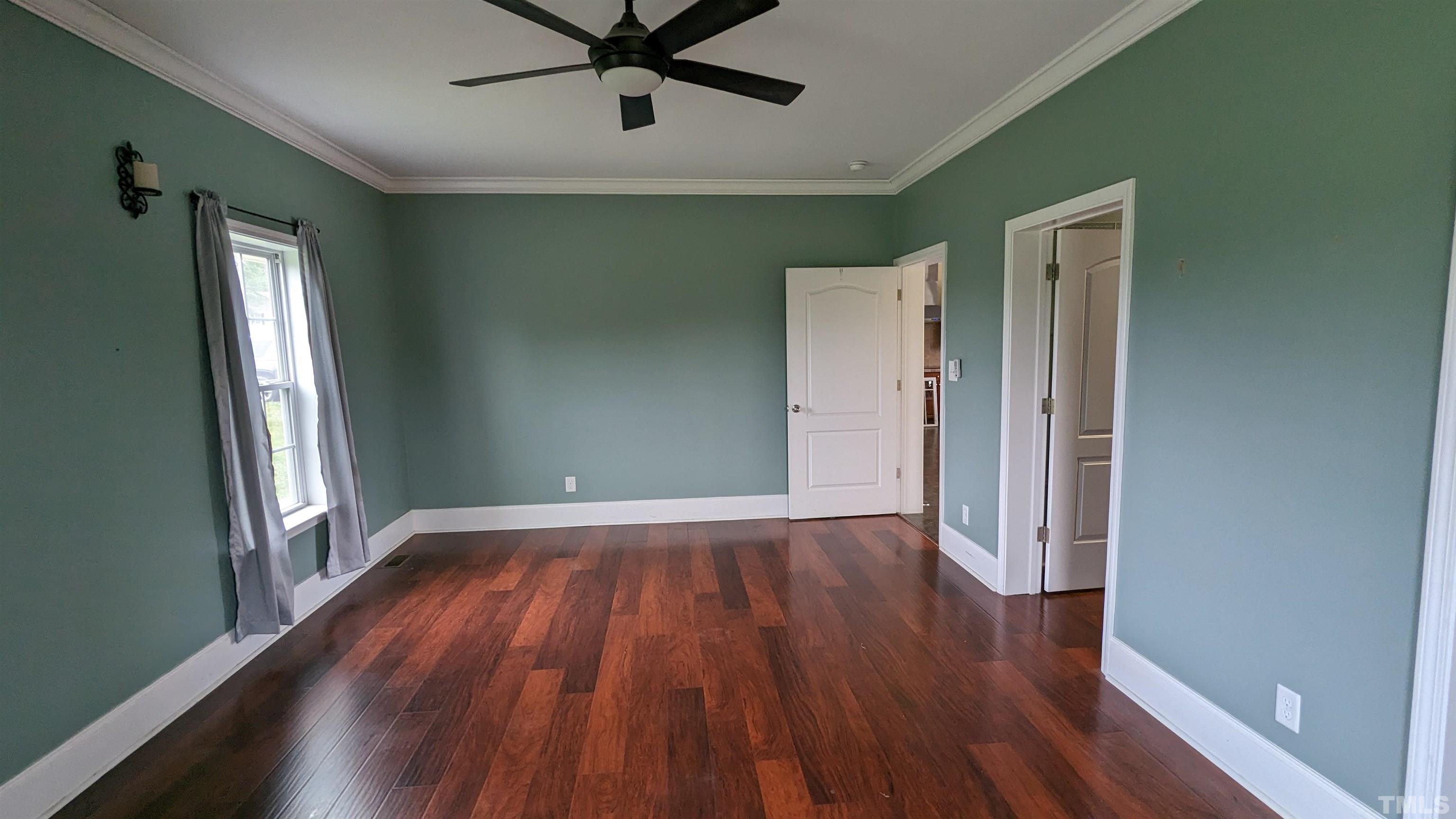 304 Bernard Purvis Road Bennett, NC 27208 - Photo 7 of 33 wooden floor in an empty room with a window