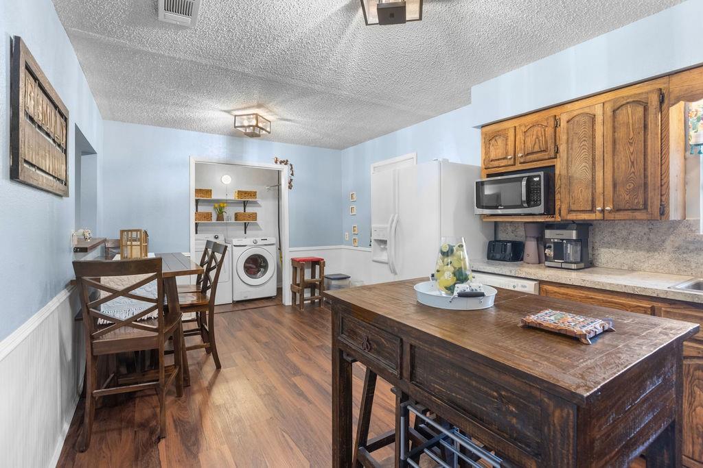 1320 Elm Street Bonham, TX 75418 - Photo 12 of 40 a kitchen with a table chairs stove and microwave