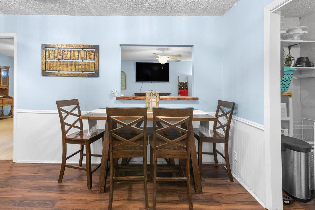 1320 Elm Street Bonham, TX 75418 - Photo 15 of 40 a view of a dining room with furniture and wooden floor