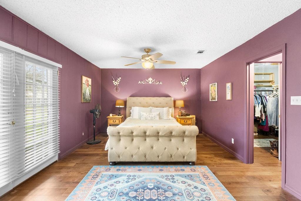 1320 Elm Street Bonham, TX 75418 - Photo 17 of 40 a large room with wooden floor and a chandelier