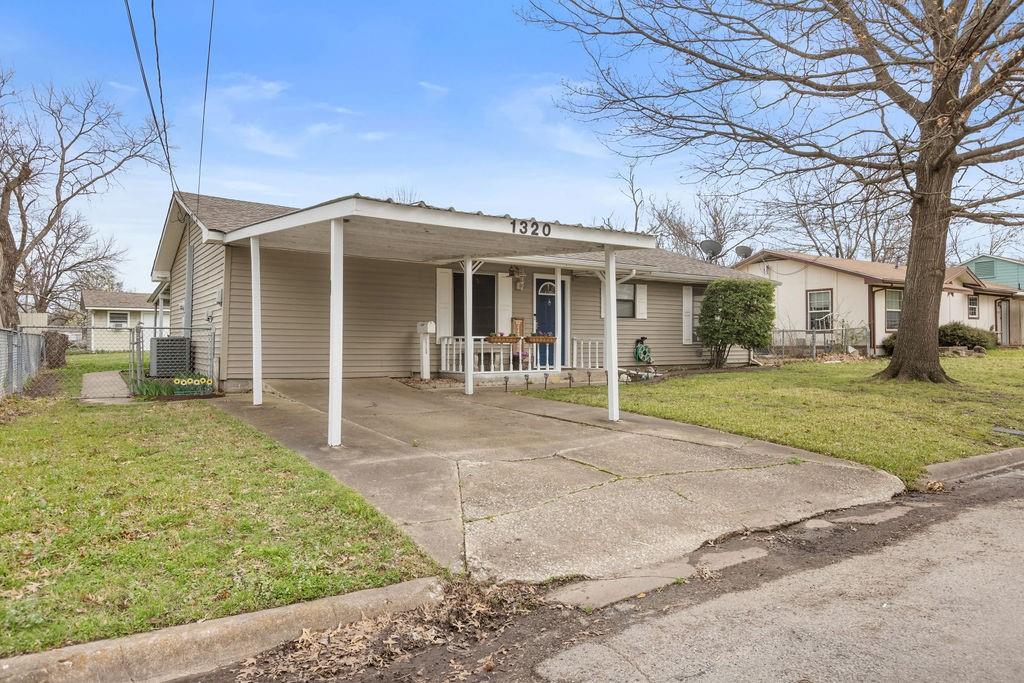 1320 Elm Street Bonham, TX 75418 - Photo 2 of 40 a front view of a house with garden