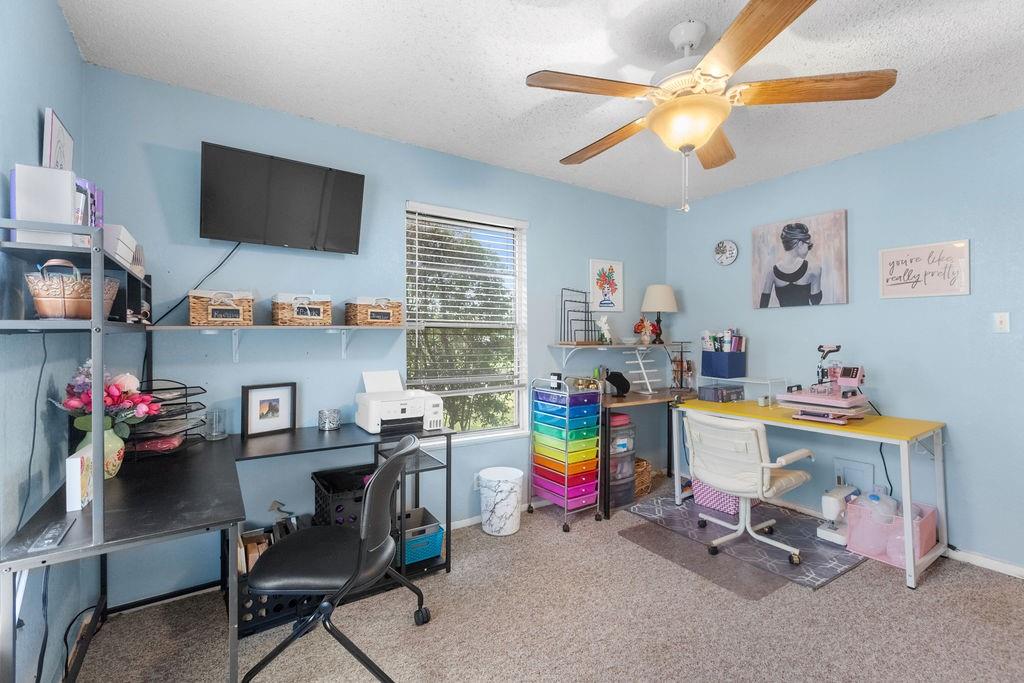 1320 Elm Street Bonham, TX 75418 - Photo 23 of 40 a room with furniture and a flat screen tv