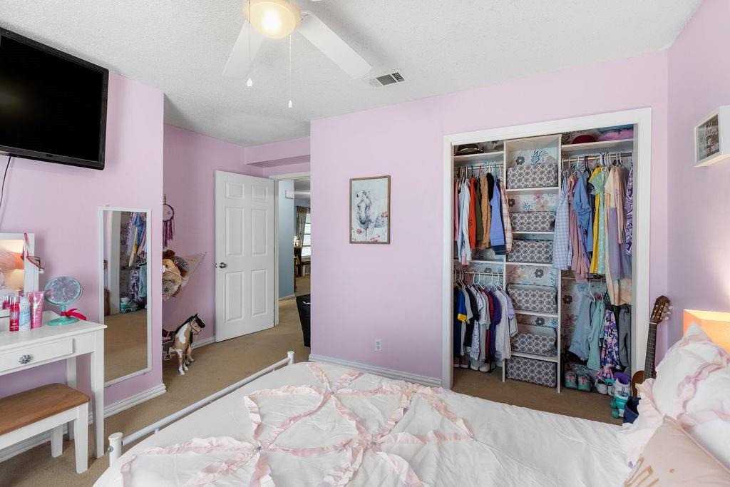 1320 Elm Street Bonham, TX 75418 - Photo 26 of 40 a bedroom with a bed and a flat screen tv
