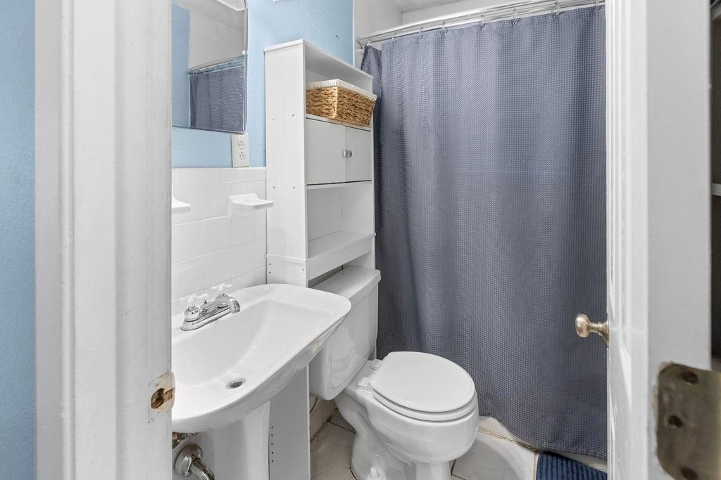 1320 Elm Street Bonham, TX 75418 - Photo 29 of 40 a bathroom with a sink a toilet and shower