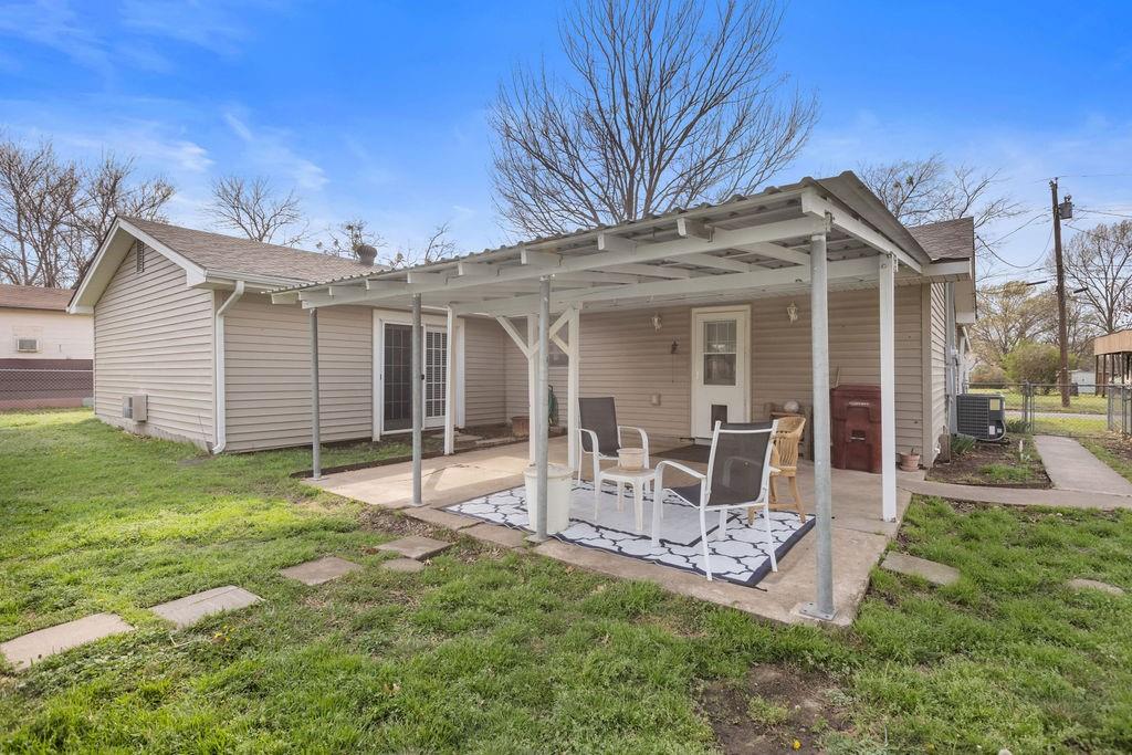 1320 Elm Street Bonham, TX 75418 - Photo 31 of 40 a view of a house with a yard and sitting area