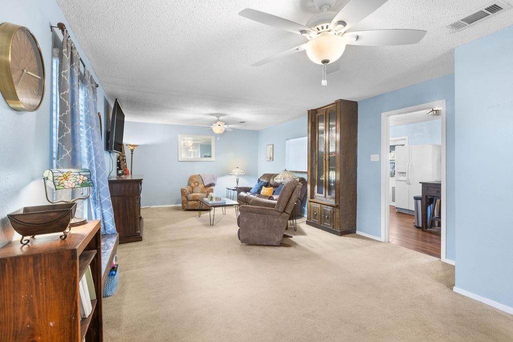 1320 Elm Street Bonham, TX 75418 - Photo 6 of 40 a living room with furniture and a chandelier