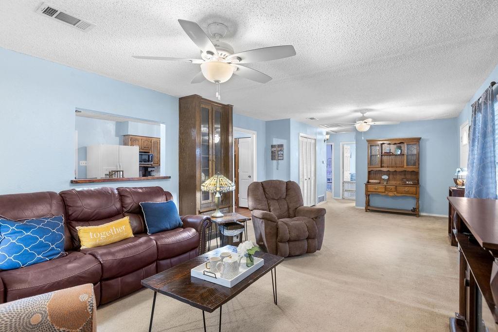 1320 Elm Street Bonham, TX 75418 - Photo 7 of 40 a living room with furniture and a chandelier
