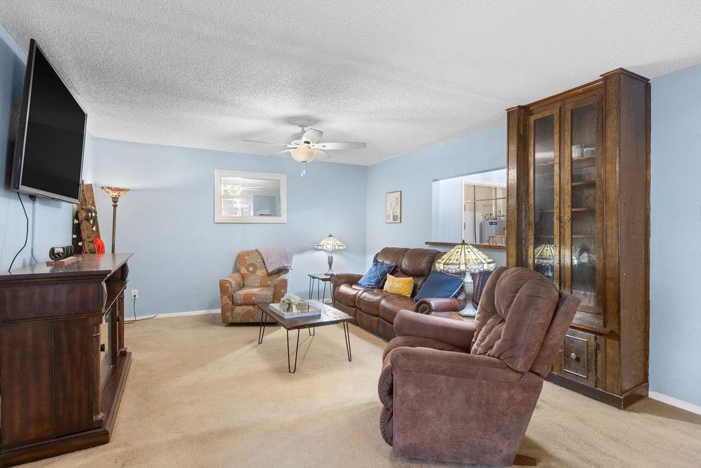 1320 Elm Street Bonham, TX 75418 - Photo 8 of 40 a living room with furniture a flat screen tv and a window