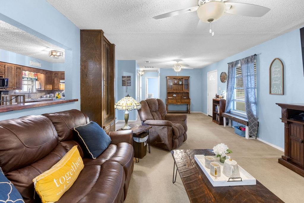 1320 Elm Street Bonham, TX 75418 - Photo 9 of 40 a living room with furniture and a flat screen tv