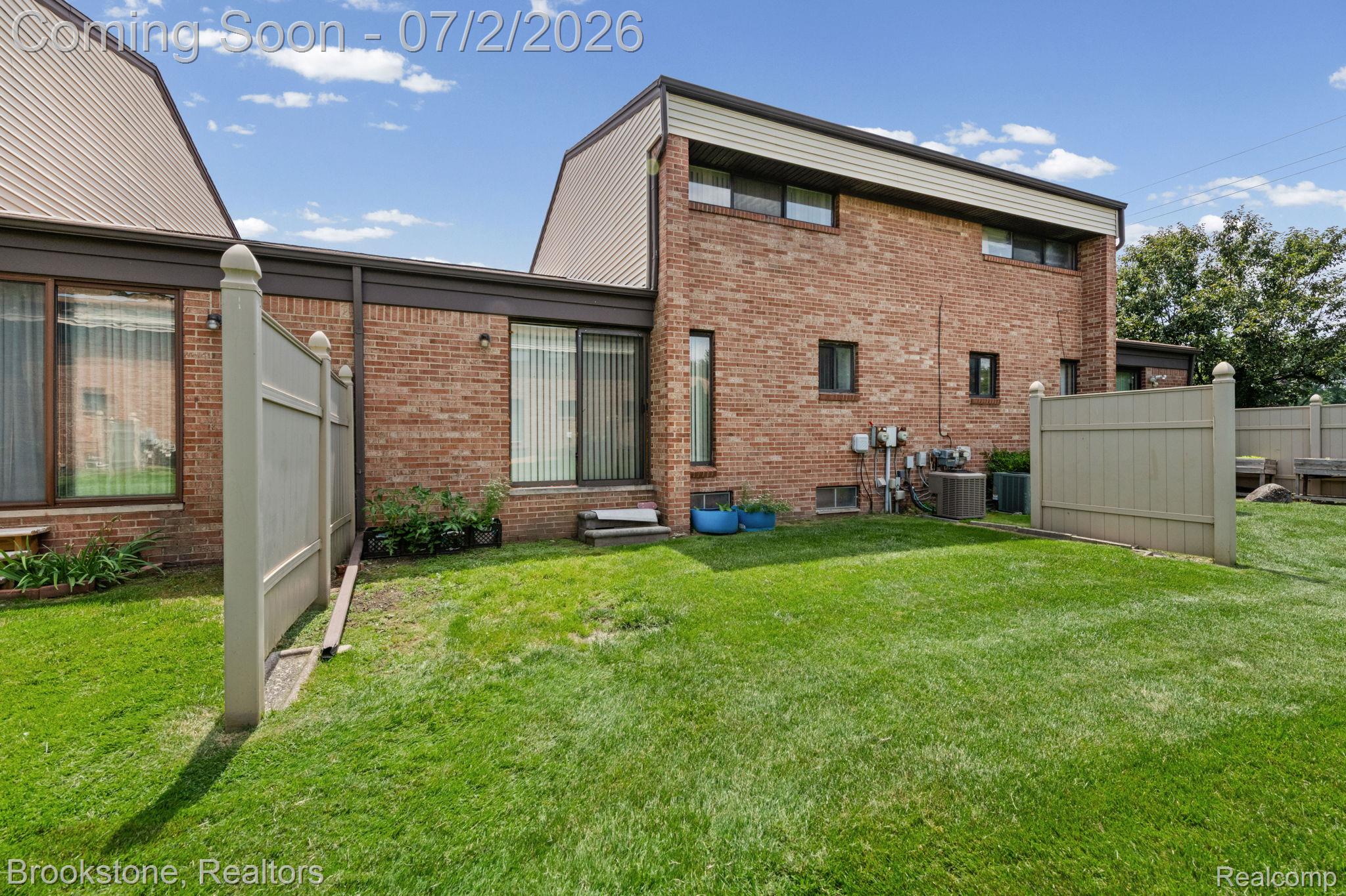 1925 Nicholas Court Warren, MI 48092 - Photo 24 of 26 Expansive green lawn bordering brick exterior with multiple windows