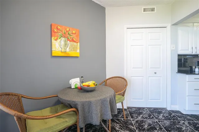 a view of a workspace with furniture and window