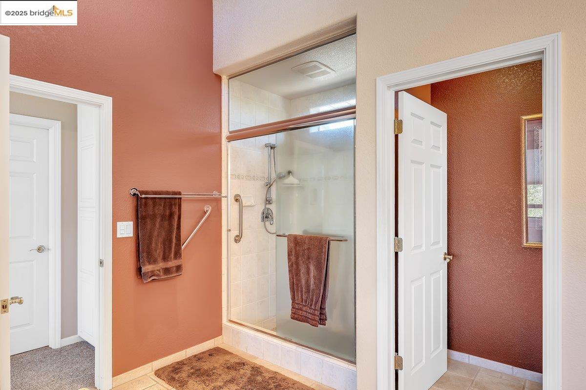 13700 Clements Road Groveland, CA 95321 - Photo 32 of 93 Full bathroom with a textured wall, a shower stall, and light tile patterned floors