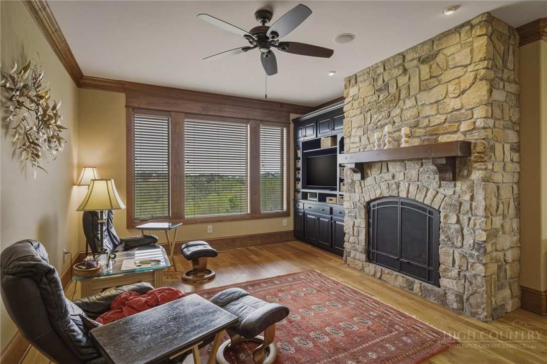 1638 Johns Ridge Parkway Lenoir, NC 28645 - Photo 13 of 50 a living room with furniture a fireplace and a floor to ceiling window