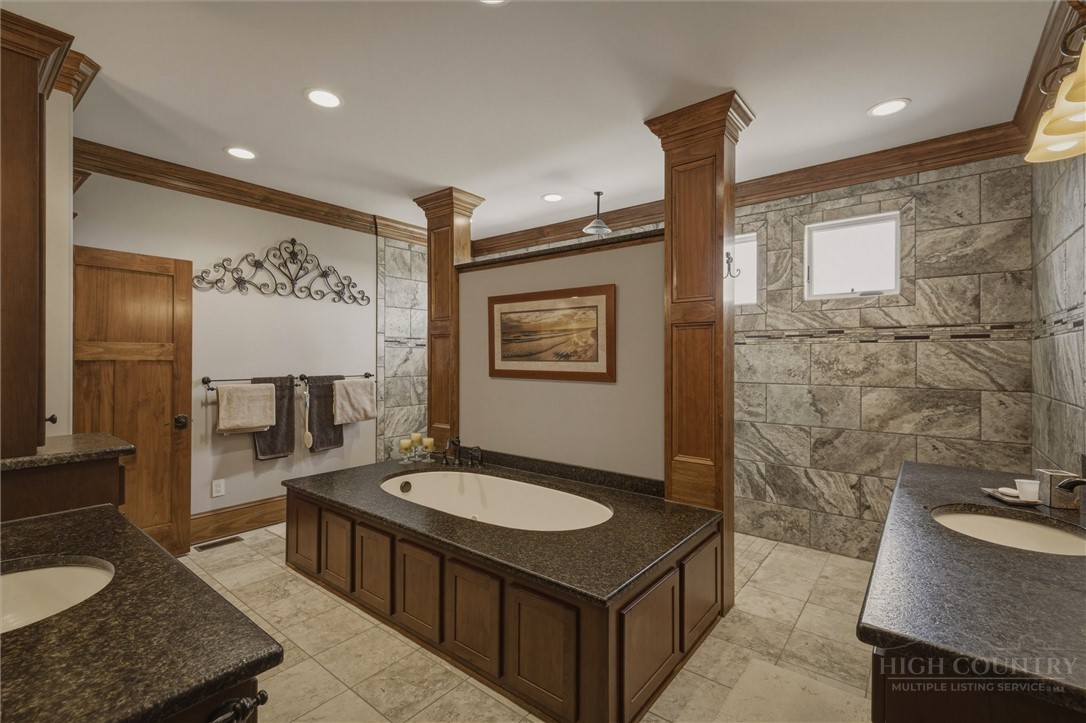1638 Johns Ridge Parkway Lenoir, NC 28645 - Photo 15 of 50 a bathroom with a sink double vanity granite tub shower and a mirror