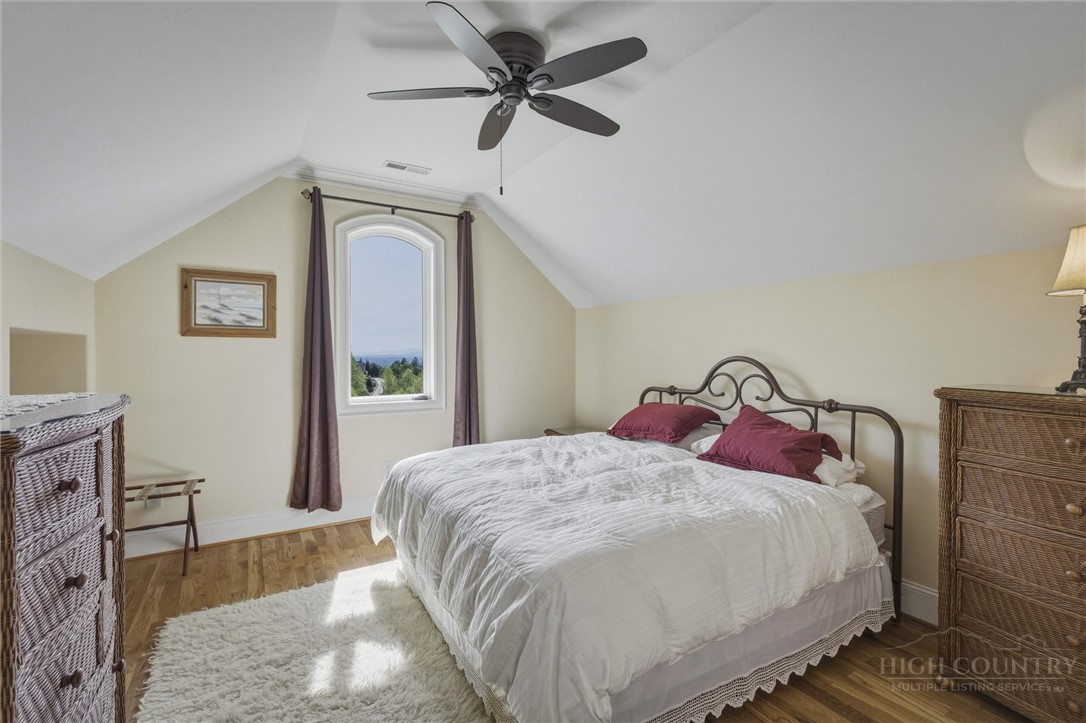 1638 Johns Ridge Parkway Lenoir, NC 28645 - Photo 22 of 50 a bedroom with a bed and a chandelier