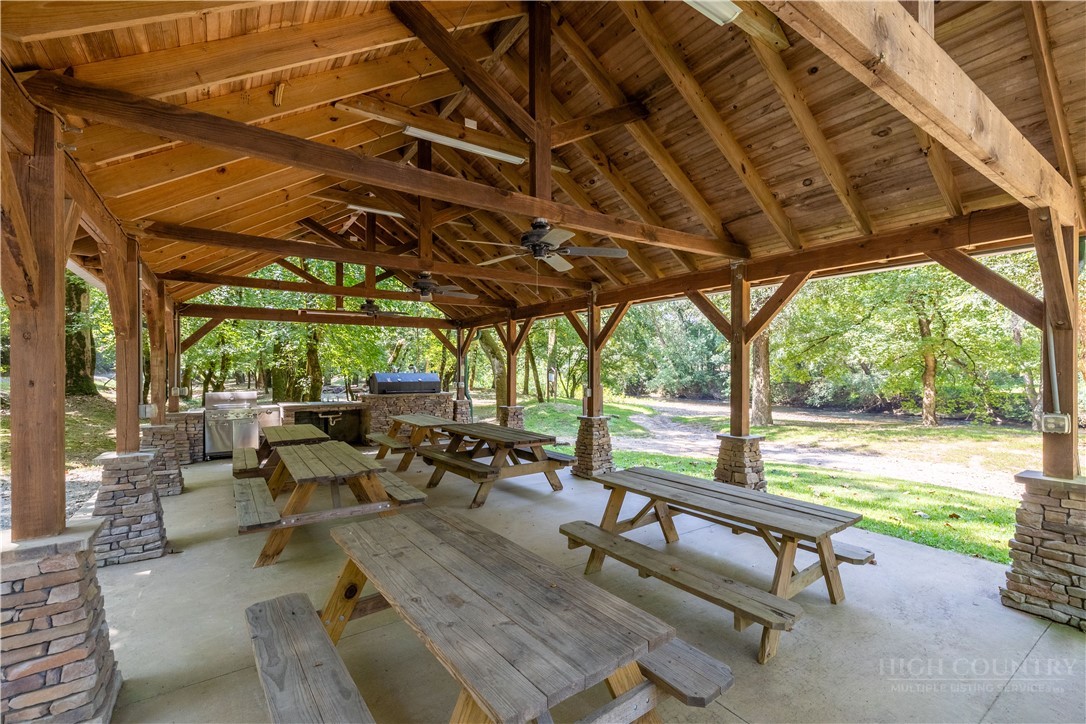 1638 Johns Ridge Parkway Lenoir, NC 28645 - Photo 44 of 50 a view of a patio with table and chairs under an umbrella with a small yard
