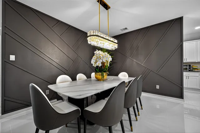 a dining room with furniture and chandelier