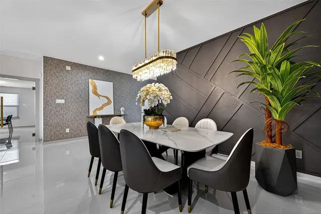 a dining room filled with furniture and chandelier