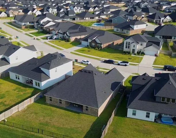 an aerial view of a house with a swimming pool
