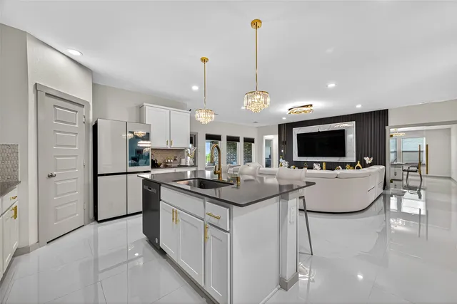 a kitchen with stainless steel appliances granite countertop a sink a stove and cabinets