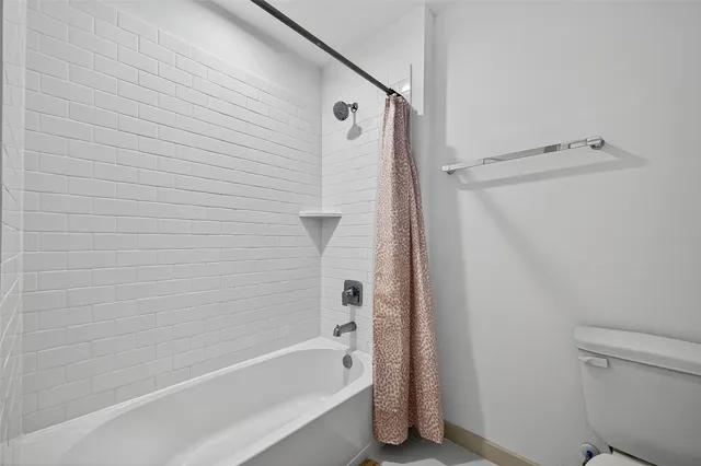 a bathroom with a double vanity sink toilet and a mirror