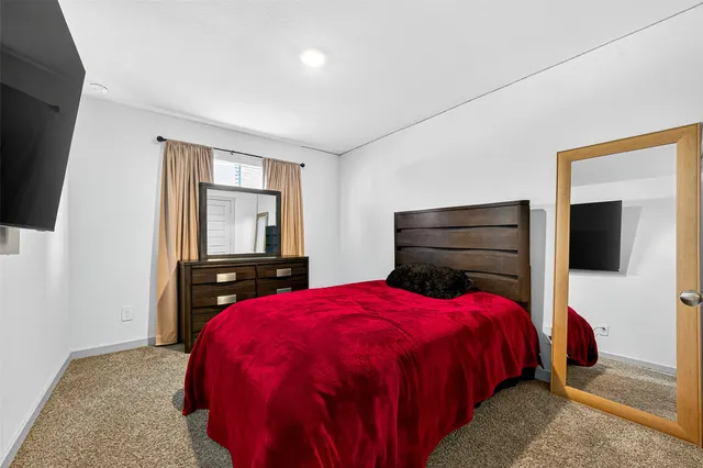 a bedroom with a bed and a desk