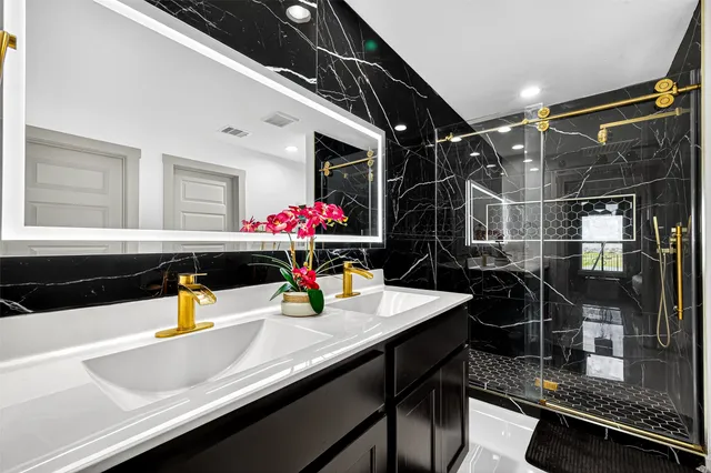 a living room with a bed furniture and a flat screen tv