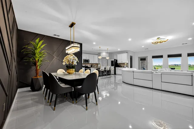 a living room with furniture and kitchen view