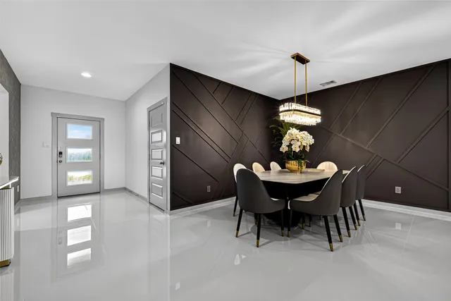a view of a dining room with furniture and chandelier