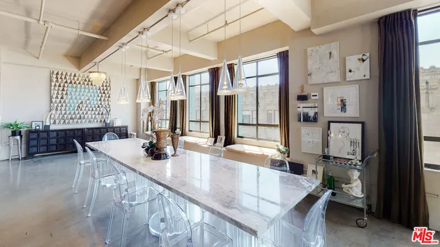 a dining hall with stainless steel appliances granite countertop a sink and cabinets