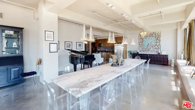 a kitchen with stainless steel appliances granite countertop a refrigerator a stove and a sink with wooden floor