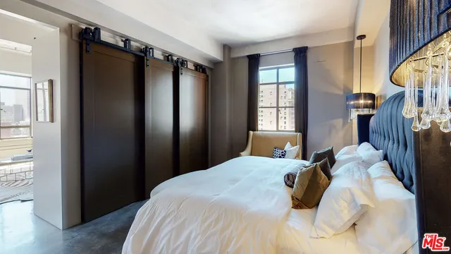 a bedroom with a bed window and walk in closet