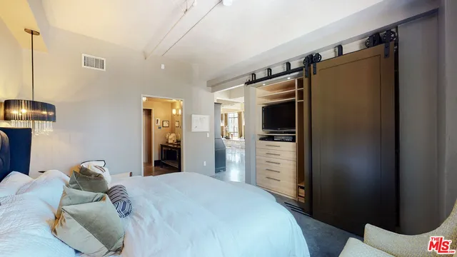 a bed room with a bed and a television