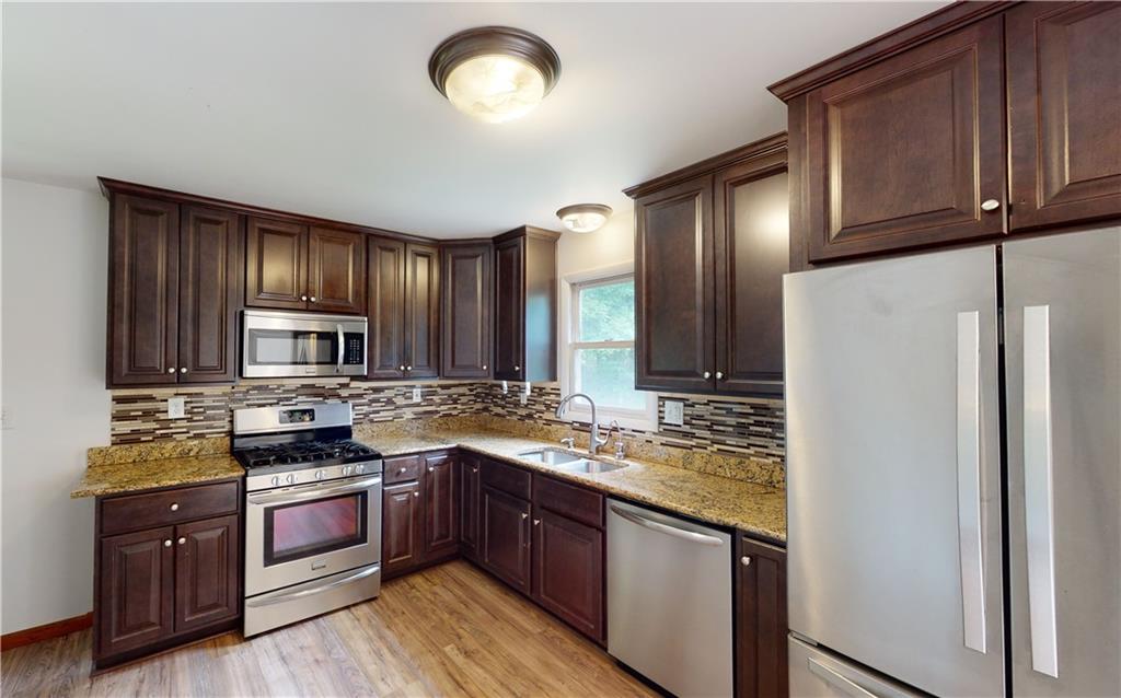 2234 Branchton Road Hilliards, PA 16040 - Photo 11 of 34 a kitchen with stainless steel appliances granite countertop wooden cabinets a stove top oven a sink and dishwasher