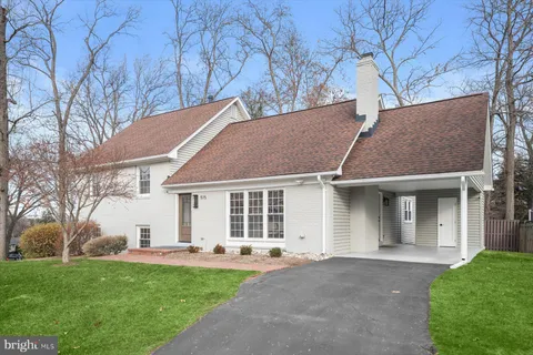 a house that has a tree in front of it