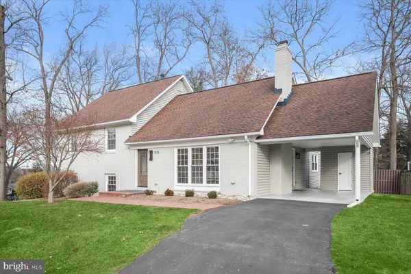 a house that has a tree in front of it