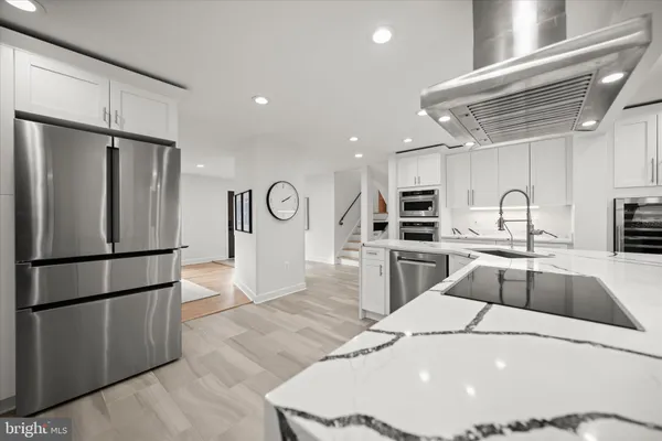 a kitchen with granite countertop a refrigerator and a sink