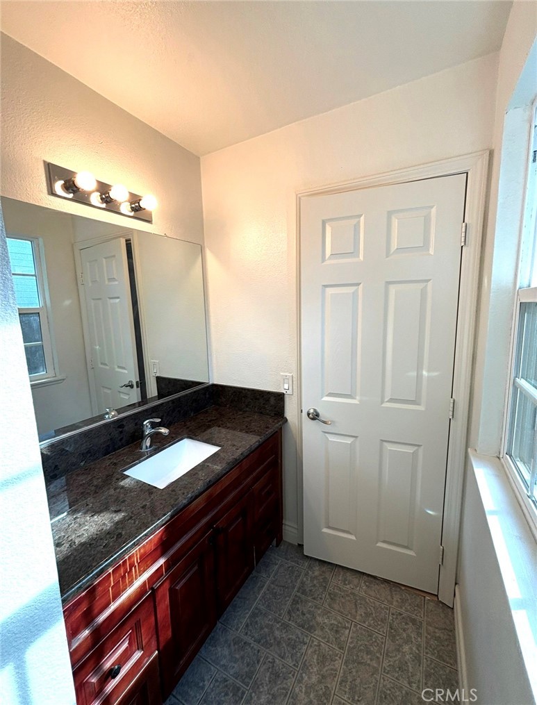 1164 Massachusetts Avenue Riverside, CA 92507 - Photo 11 of 14 a bathroom with a sink and a mirror