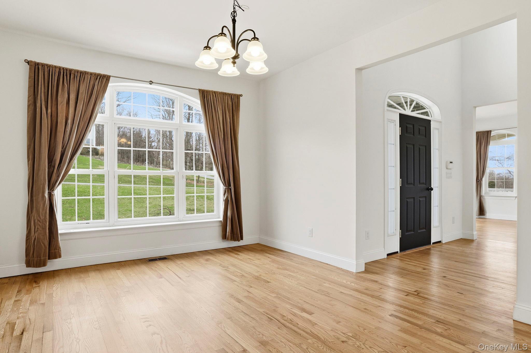 37 Willets Way Newburgh, NY 12550 - Photo 12 of 48 a view of an empty room with wooden floor and a window