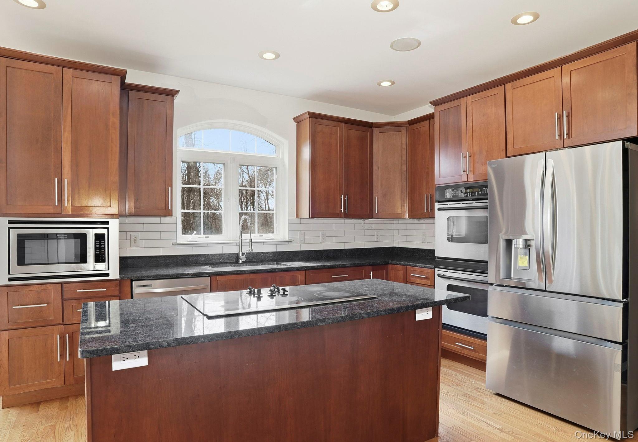 37 Willets Way Newburgh, NY 12550 - Photo 16 of 48 a kitchen with stainless steel appliances granite countertop a refrigerator a stove and a sink with wooden cabinets