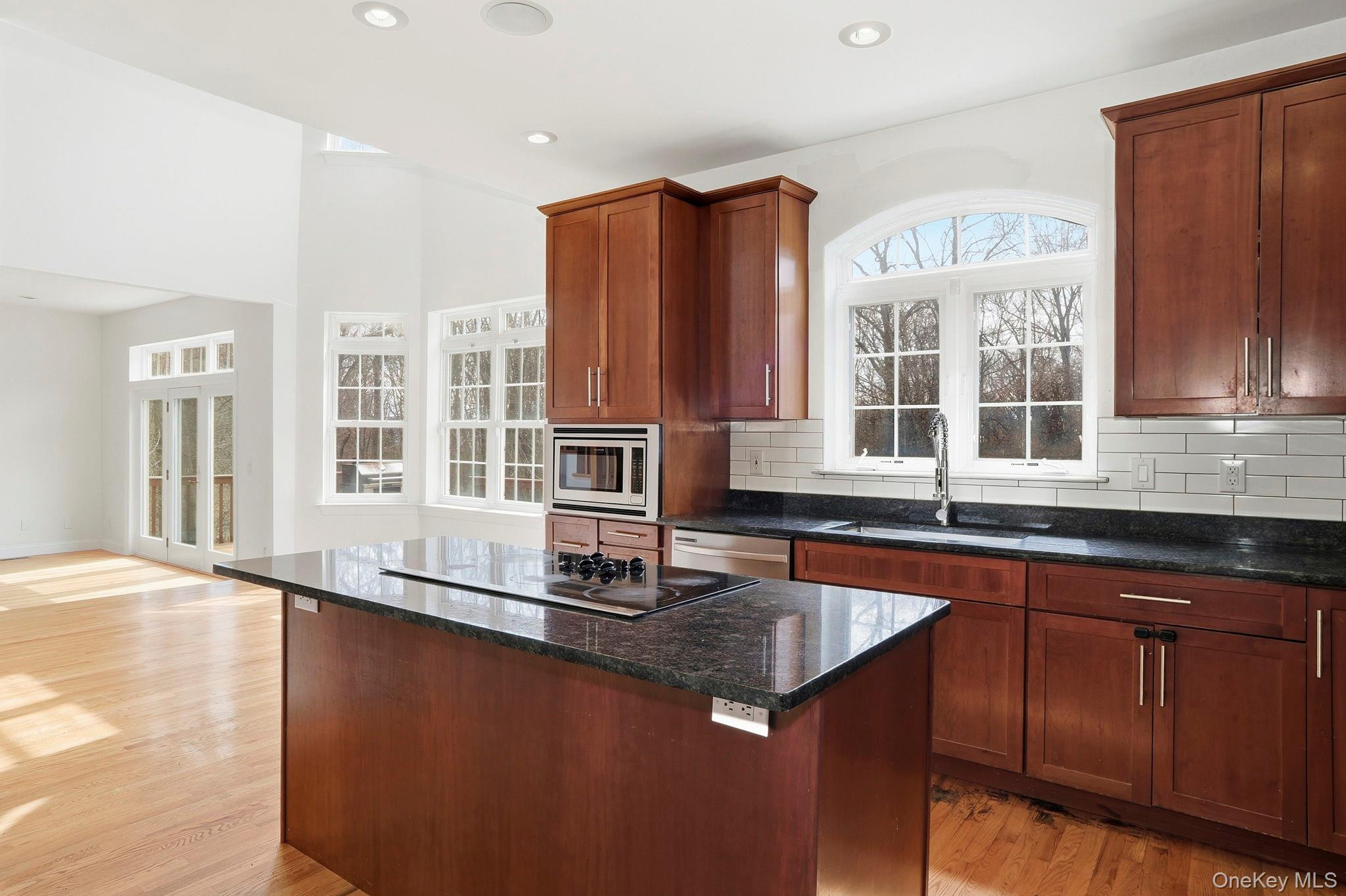 37 Willets Way Newburgh, NY 12550 - Photo 17 of 48 a kitchen with stainless steel appliances granite countertop a sink and a granite counter tops with wooden floors