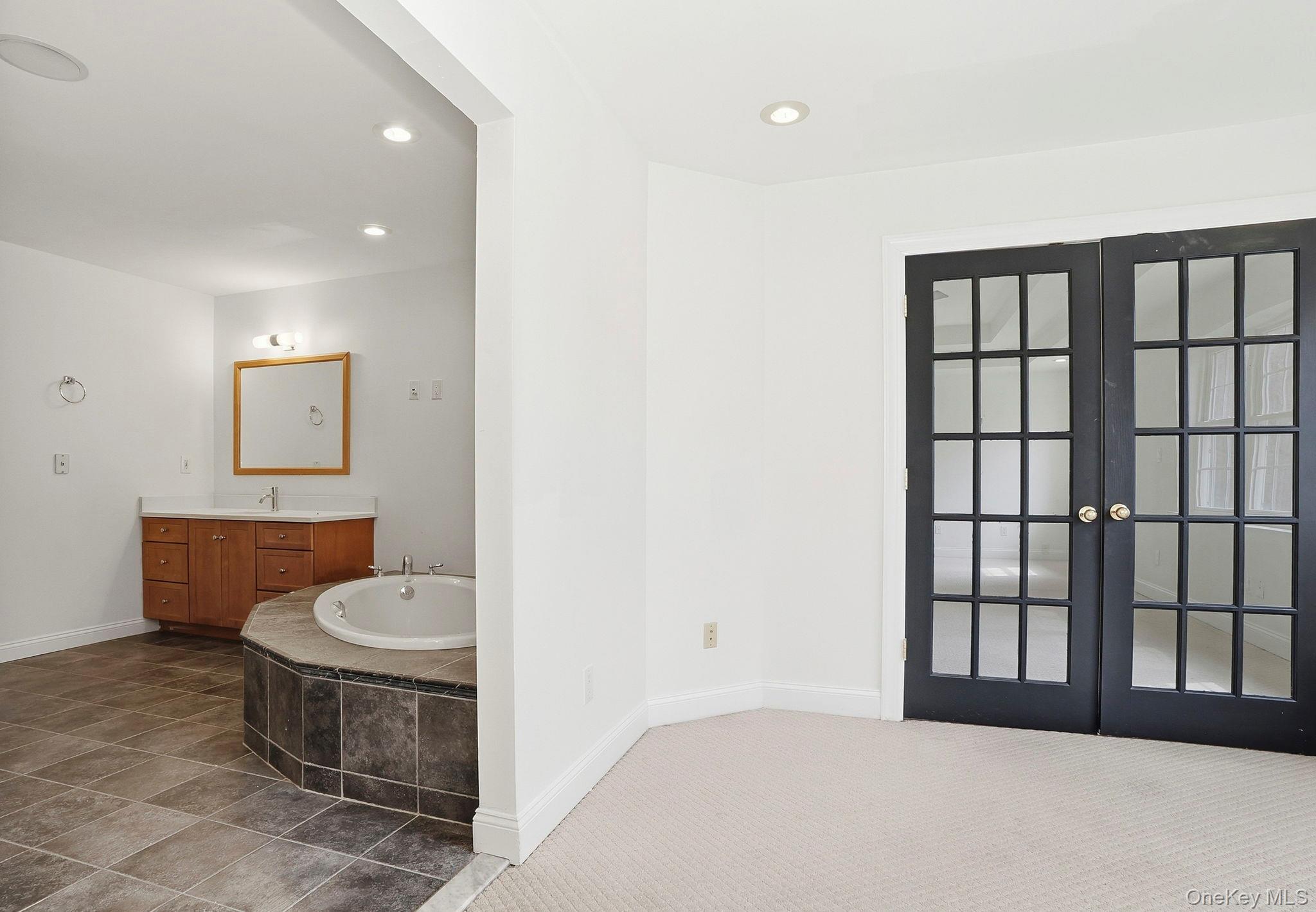 37 Willets Way Newburgh, NY 12550 - Photo 27 of 48 a spacious bathroom with a toilet a sink and mirror
