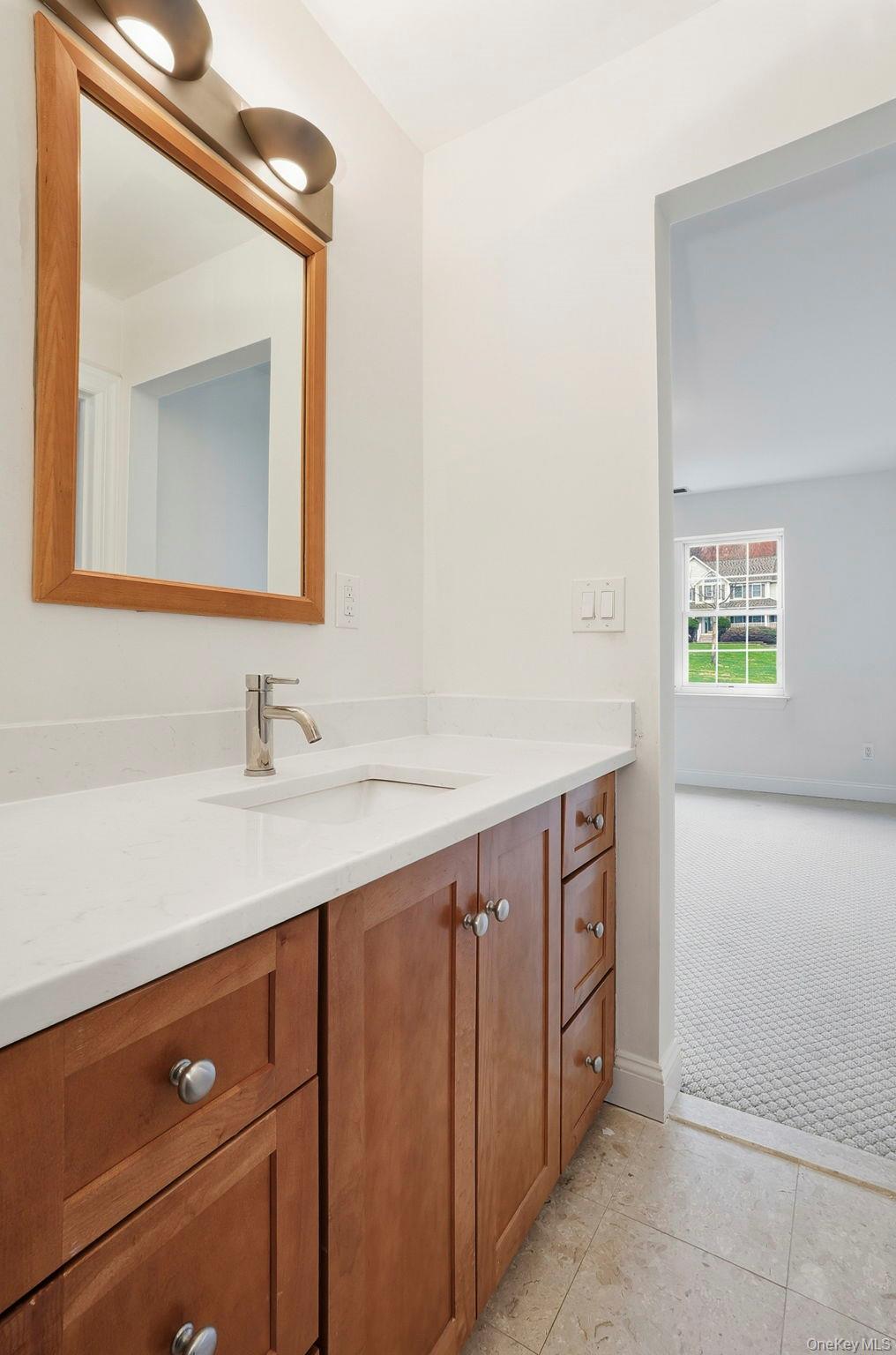 37 Willets Way Newburgh, NY 12550 - Photo 35 of 48 a bathroom with a sink a vanity and a mirror